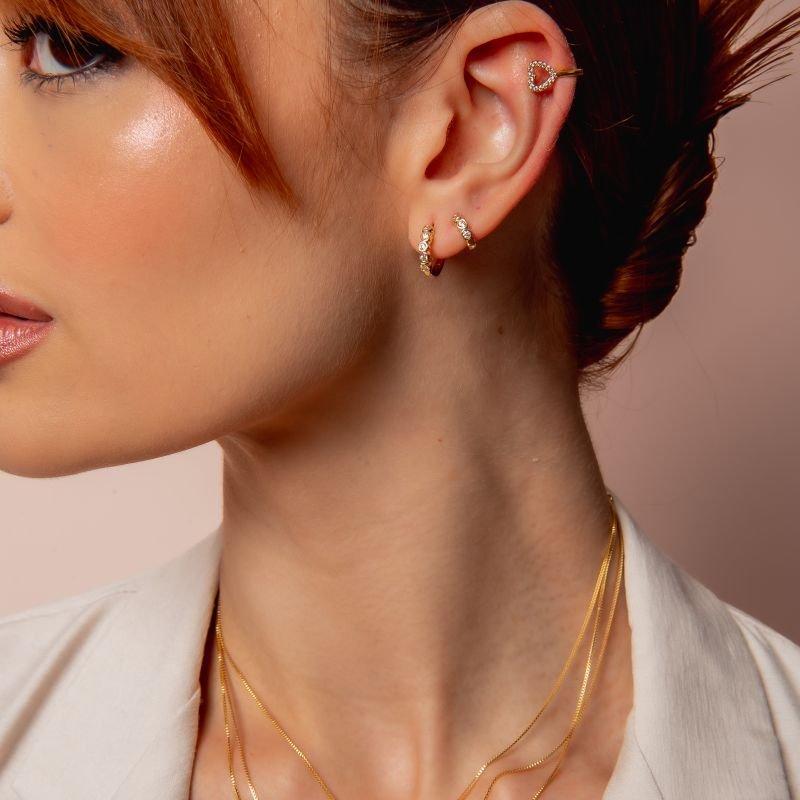 PIERCING CORAÇÃO VAZADO ZIRCÔNIA DOURADO FOLHEADO