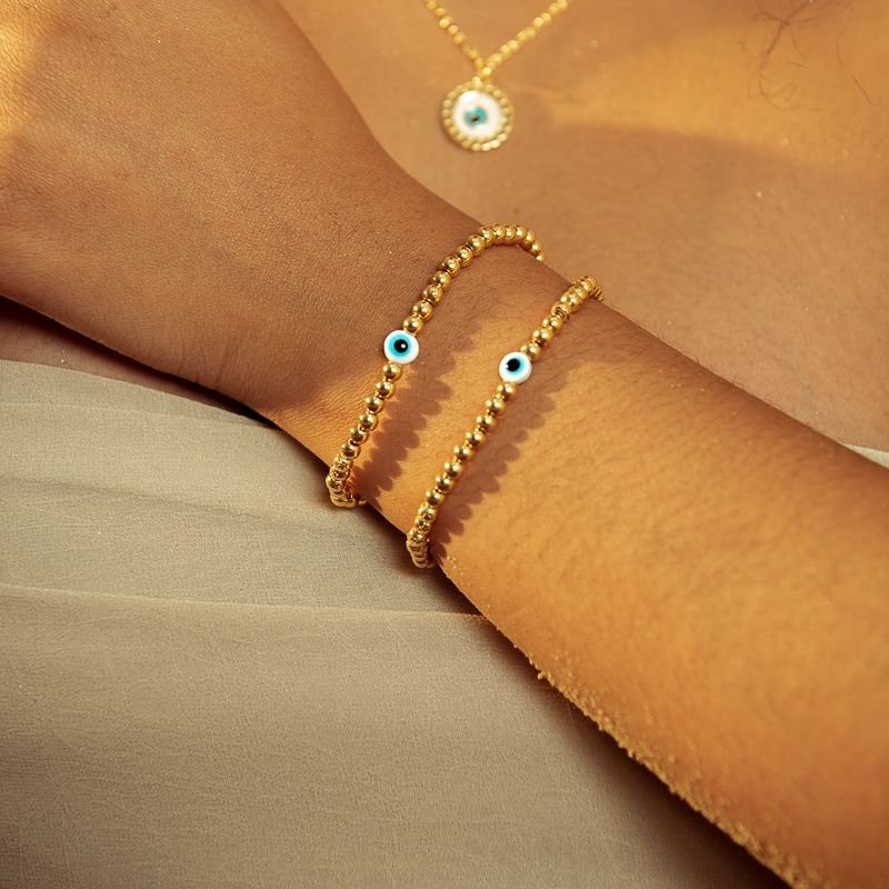 PULSEIRA BOLINHAS ABS COM OLHO GREGO DOURADO FOLHEADO